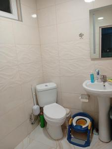 a bathroom with a toilet and a sink at Nika's Home in Ureki