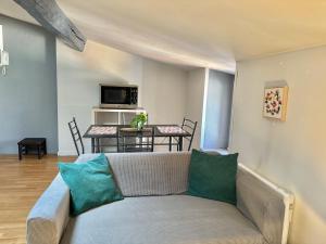a living room with a couch and a table at Zen Appartement Centre-ville historique in Niort