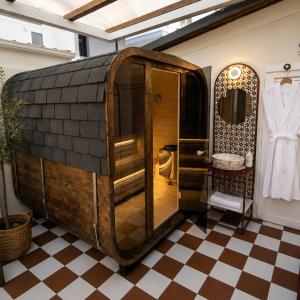 a bathroom with a wooden shower in a room at ELLE Rooms & Suites in Paralia Katerinis +92 photos