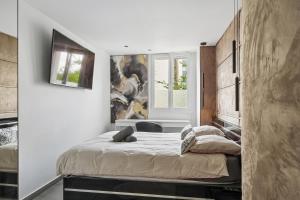 a bedroom with a large bed in a room at Pop Eurexpo - Parking Privé, Terrasse, Climatisation in Bron