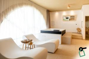 a living room with white furniture and a large window at Hotiday Gallipoli Sannicola in Gallipoli