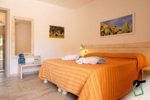 a bedroom with a bed with towels on it at Hotiday Gallipoli Sannicola in Gallipoli