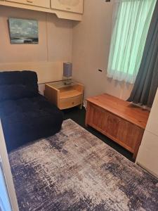 a bedroom with a bed and a table and a window at An Tigin in Cahersiveen