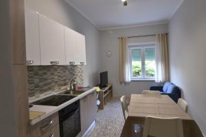 a kitchen and dining room with a table and a kitchen and a dining room at La Spiritiera in Minturno