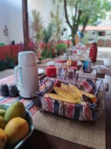 a table with a tray of fruit and a plate of food at Serrambi Praia Suites in Porto De Galinhas +49 photos