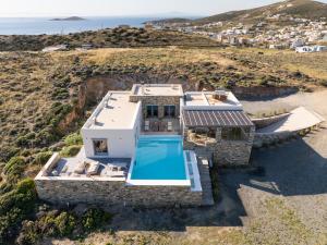 an aerial view of a house with a swimming pool at Villa Cycladic View Syros in Azolimnos Syros