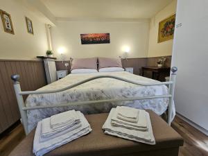 a bedroom with a bed with towels on a table at Locazione Turistica LBS, San Giacomo , Spoleto in San Giacomo