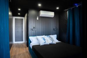 a bedroom with a bed with blue curtains and a window at House Boat Cervia in Cervia