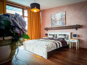 a bedroom with a white bed and a window at Apartments Sofia - Luxury Penthouse in Liptovský Mikuláš