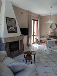 a living room with a couch and a fireplace at Villa Rosette Ile du levant in Hyères