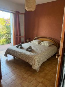a bedroom with a large bed with at Villa Rosette Ile du levant in Hyères