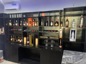a bar with a lot of bottles of alcohol at Adwels Hotel&Suites in Akure