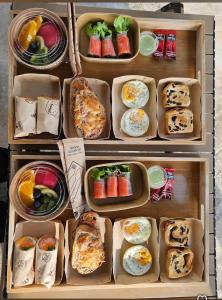 a refrigerator filled with trays of food at Tiny house homestay & cafe 5 units in Ban Mai Lao Yao