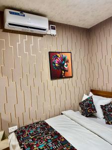 a bedroom with a bed and a wall at Cozy haven in Kampala