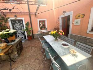 a dining room with a table and chairs and flowers at Domačija Harmonija in Vremski Britof +16 photos