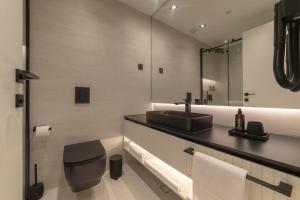 a bathroom with a sink and a mirror at Home apartments in Mostar +107 photos