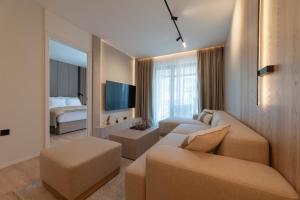 a living room with a couch and a bed at Home apartments in Mostar