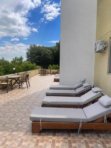a row of chaise lounges on a patio at Hotel Garden Albania in Golem +26 photos