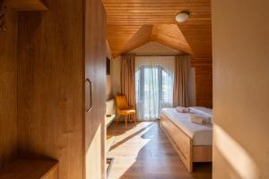 a bedroom with a bed and a chair in a room at Hotel Babuda in Mestia in Mestia