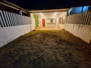 an empty garage at night with a yellow chair at Casa Mayan in La Vigueta