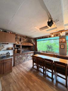 a kitchen with a large wooden table in a room at Vikendica Brda in Banja Luka +16 photos