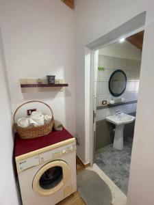 a laundry room with a washing machine and a sink at Diarla's Home in Fier +139 photos