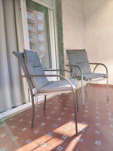 two chairs sitting on a porch near a window at Paseo el Saladar in Denia