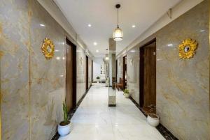 a hallway with potted plants on the walls of a building at Hotel Velvet Dreams Inn & Banquet in Kharar