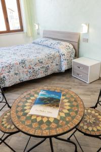 a bedroom with a bed and a table with a book on it at La dolce vita in Agerola