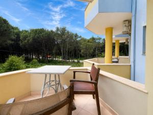 a balcony with a table and chairs and a view at Hotel Garden Albania in Golem