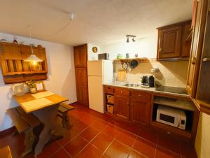 a kitchen with wooden cabinets and a white refrigerator at Casa da Torre in Sao Pedro de Tomar +11 photos