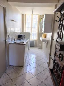 a kitchen with a sink and a counter top at Studio chez Jef in Nuits-Saint-Georges +3 photos