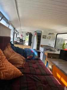 an rv with a bed and a table in it at The Bru Bus in Maybole