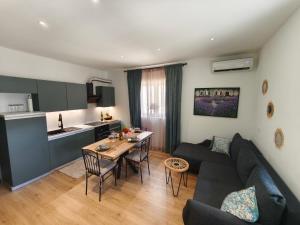 a living room with a couch and a table at Olive Tree Apartment in Kaštela