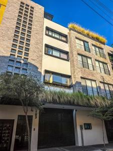 an apartment building with plants on top of it at Bogart 206 in Guadalajara