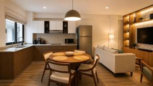 a kitchen and dining room with a table and a couch at Bogart 206 in Guadalajara