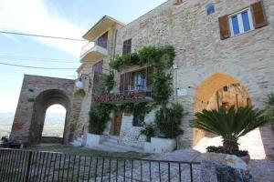 a brick building with a balcony with plants on it at B&B Emilia's House in Roseto degli Abruzzi