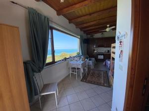 a kitchen with a table and a view of the ocean at B&B Emilia's House in Roseto degli Abruzzi