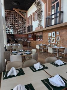 a restaurant with tables and chairs with napkins on them at Flat Parque do Cais in Recife By Flatbpaiva in Recife