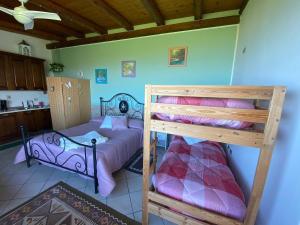 a bedroom with two bunk beds and a kitchen at B&B Emilia's House in Roseto degli Abruzzi +46 photos