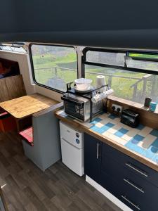 a kitchen in an rv with a counter top at The Bru Bus in Maybole