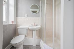 a bathroom with a toilet and a sink and a shower at The Capsule Room at The Lairbeck in Keswick in Keswick