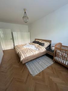 a bedroom with a bed and a crib at Exnárova in Prievoz
