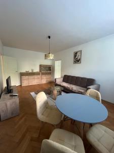 a living room with a table and a couch at Exnárova in Prievoz