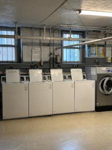 a laundry room with a bunch of washers and dryers at 8 minutes from 2026 FIFA World Cup Final! in Rutherford
