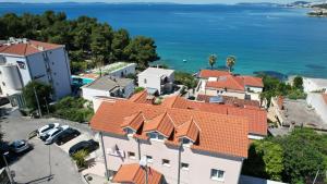 an aerial view of a town with houses and the ocean at Pink Inn in Podstrana