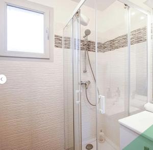 a shower with a glass door in a bathroom at Villa Near Versailles in Feucherolles