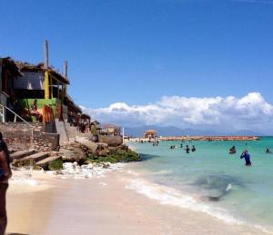 a group of people in the water on a beach at BW Hideaway in Portmore +11 photos