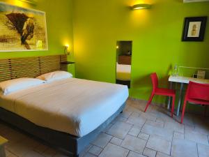 a bedroom with a bed and a table and chairs at Hotel La Posta di Torrenova in Orbetello +82 photos