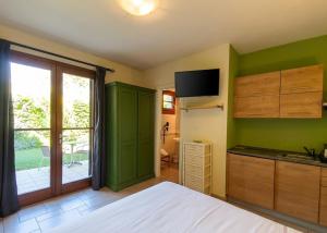 a room with a bed and a kitchen with a window at Hotel La Posta di Torrenova in Orbetello